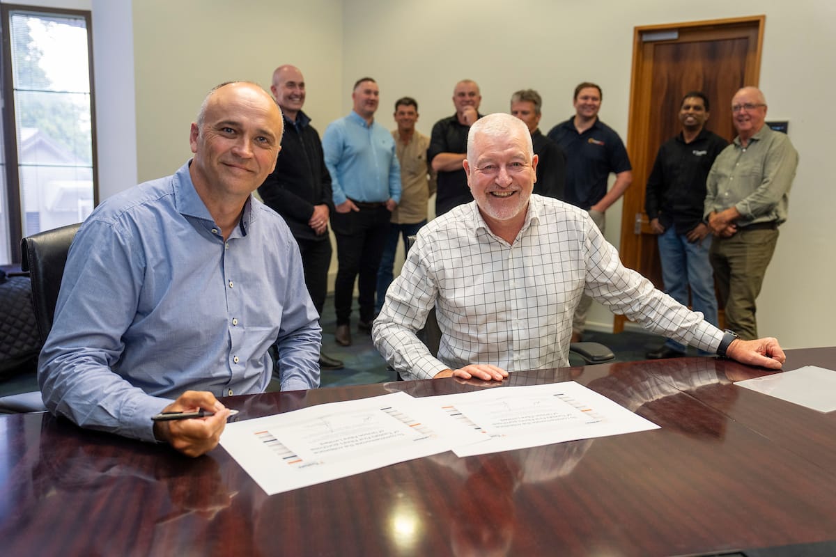 Unison Group CEO Jaun Park and Tuatahi CEO John Hanna completing the acquisition paperwork.