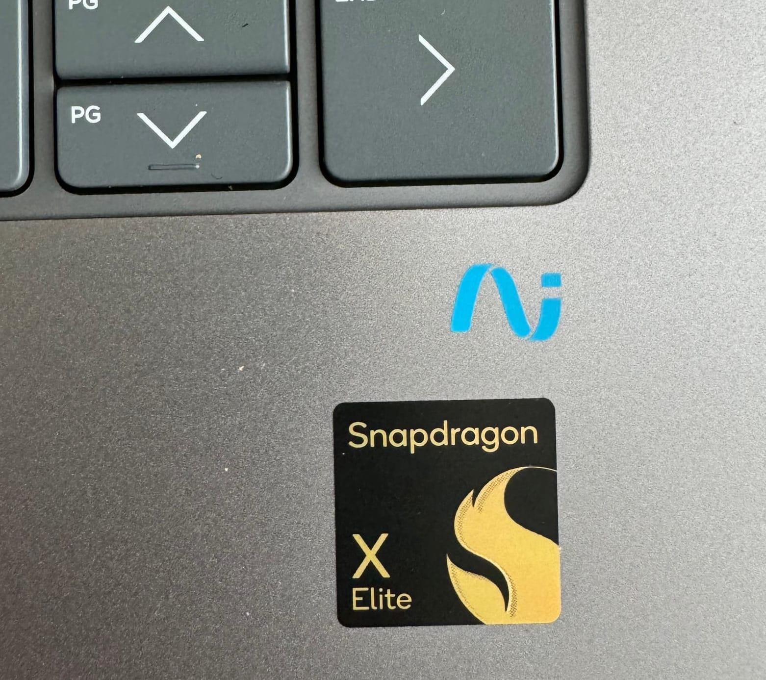 a Snapdragon X Elite badge sits a few millimetres south of a screen-printed “AI” logo.