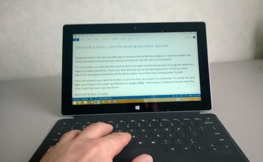 Big fingers typing on the small Microsoft Surface 2 keyboard.