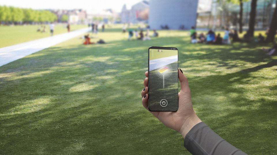 Ericsson photo of person using 5G mobile phone for augmented reality application.