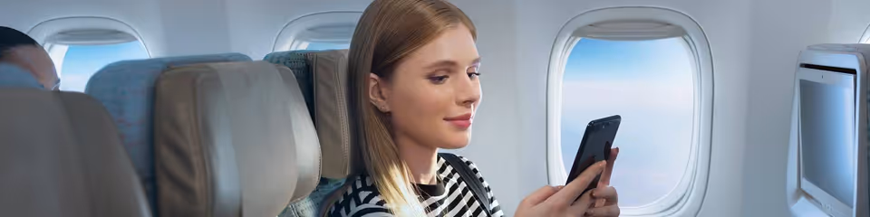 woman-using-onboard-wifi-on-phone